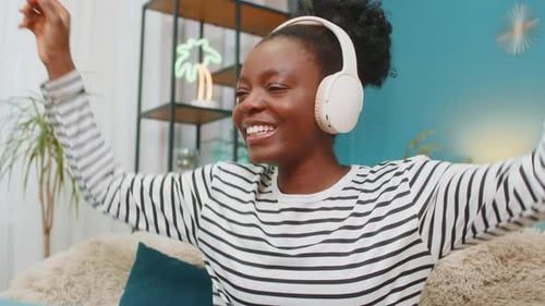 Cheerful Woman Listening to Music with Headphones