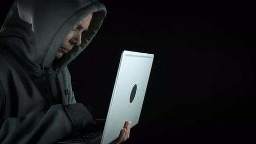 Young Adult Types on Laptop in the Dark