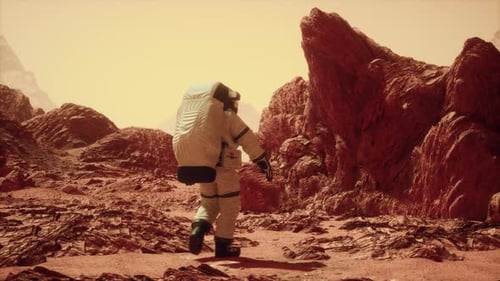 Astronaut Walking Across Rocky Mars Terrain 1
