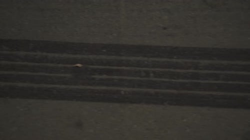 Burnout marks from tires on the ground at night