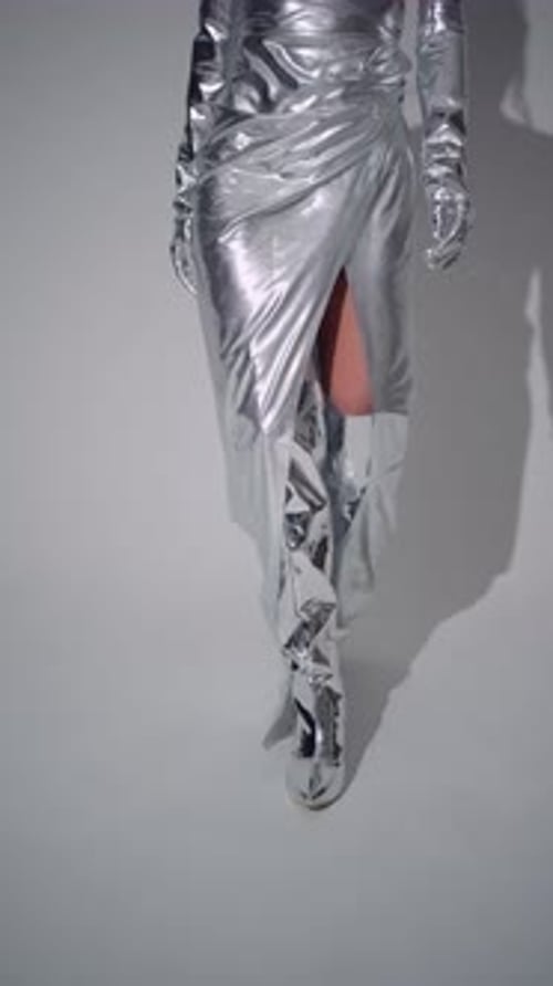 Woman in Silver Metallic Outfit Walking
