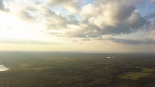 Cloudscape Over Vast Forest and River at Sunset