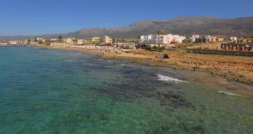 The touristic city of Stalis with beach resorts during summer. Aerial shot.
