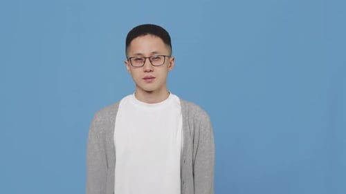 Smiling Young Adult Points to Side