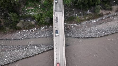 Drop down view of fly-over bridge and river with cars in Santiago, Chile