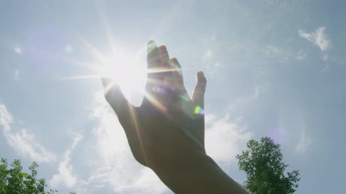 Pov Of An Hand Covering The Sun