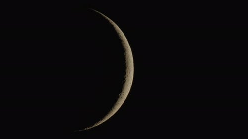 Slim Crescent Moon Glowing in Dark Sky