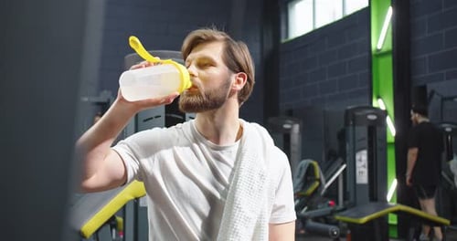 I Want to Drink Waist Up Portrait View of the Fitness Man with Towel at His Shoulder Sitting on the