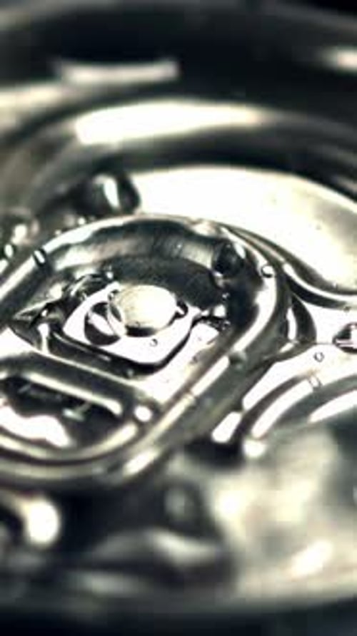 Super Slow Motion on a Tin with Beer Dripping Drops of Water with Spray Filmed on a Highspeed Camera