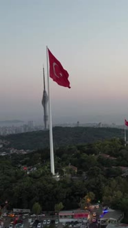 Red Flag Blowing in the Wind Above City