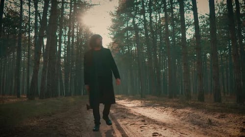 Mysterious Figure Holding Axe in Forest at Dusk Serial Killer Walking Through Woods