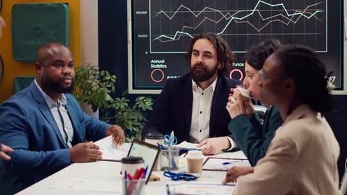 Business Analysts Meeting in a Boardroom to Discuss Project Stages and Updates
