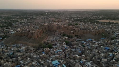 Orbit Drone Shot of Jaisalmer Fort with Houses at evening 4K View, Rajasthan, India
