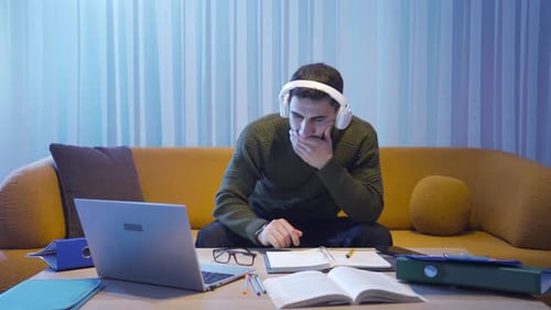 Young Adult Studying at Home with Laptop