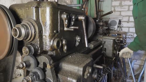 Male Hands of Mechanic in Gloves Working on Old Workbench in His Garage