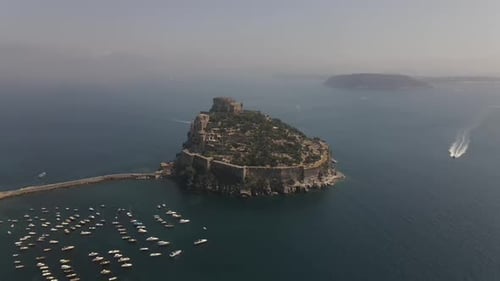Ischia, the Aragonese castle on the island of Ischia in the background of the island of Naples, in I