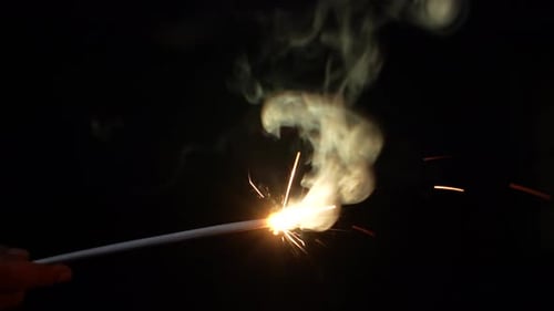 Sparkler Bursts with Light and Smoke at Night
