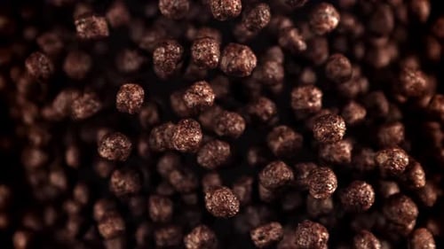 Chocolate Cereal Puffs Falling and Floating in Slow Motion