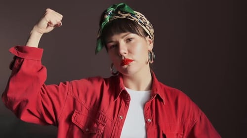 Confident Woman Posing with Arm Raised Indoors