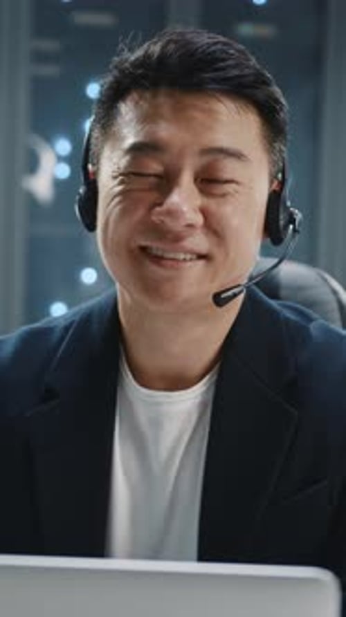 Smiling Man Wearing Headset in Data Center
