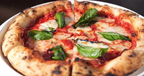 Close-Up of Delicious Pizza with Basil and Cheese