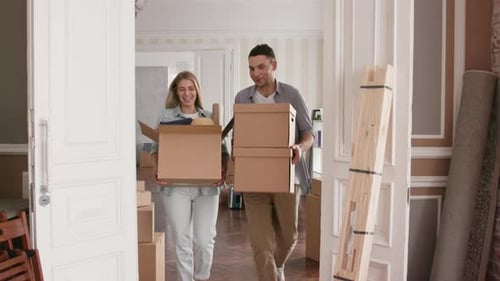 Happy Couple Moving into New Home with Boxes