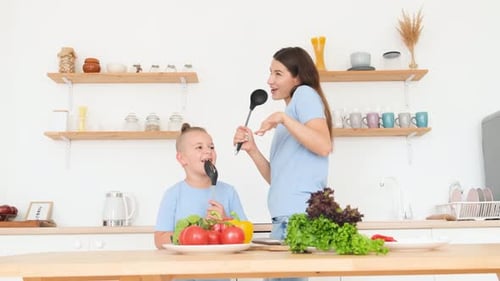 Mother and Son Singing with Kitchen Utensils