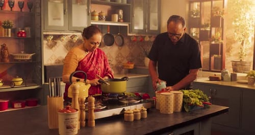 Woman Cooking and Talking with Man in Kitchen