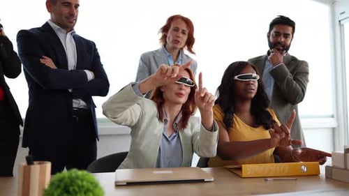 group of businessmen and businesswomen in the office using metaverse virtual reality