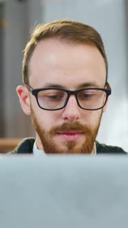 Close Up of Goodlooking Man Male Office Manager with Wellgroomed Beard in Eyeglasses Which Sitting