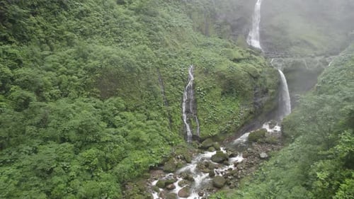Move in close drone shot into a Waterfall in the jungle Costa Rica