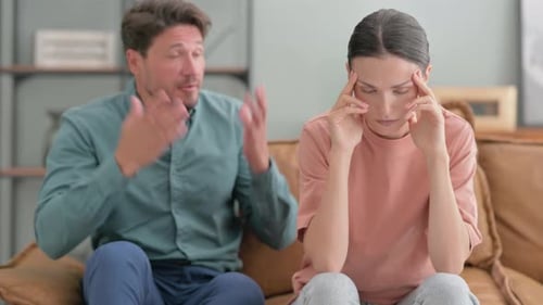 Arguing Man and Upset Woman on Sofa