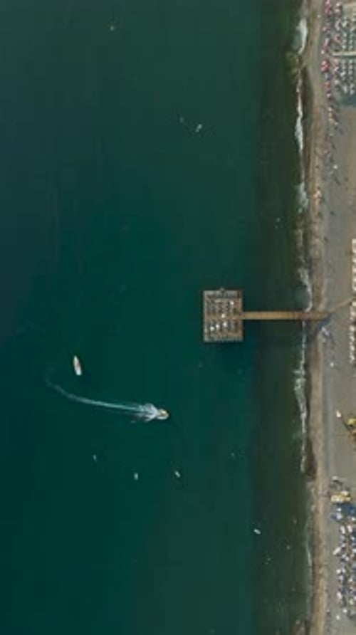 Vertical Video Aerial Elegance Wooden Hotel Pier on the Mediterranean Coastline in