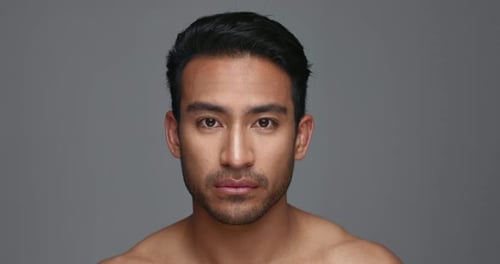 Face, cosmetics and Asian man with beauty, skincare and dermatology on a grey studio background