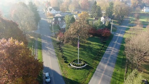 Aerial View of Autumnal Suburban Neighborhood with US Flag