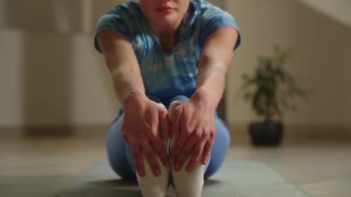 Blonde Woman Stretching Legs During Yoga at Home