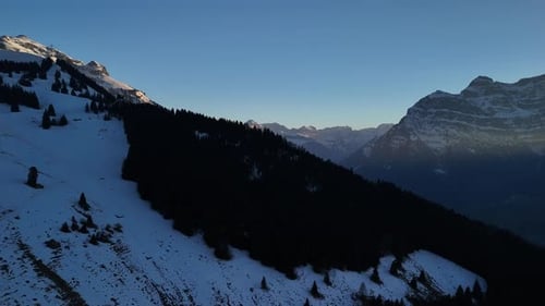 Drone Fronalpstock Switzerland alpine snow covered valley hills aerial landscape