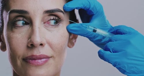 Woman, smile and injection in studio for plastic surgery, cosmetology and anti aging procedure