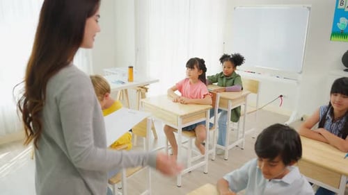 Group of student learn with teacher in classroom at elementary school.