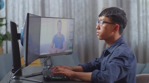 Asian Boy Programmer Learning Online From Teacher While Creating Software Engineer Developing App