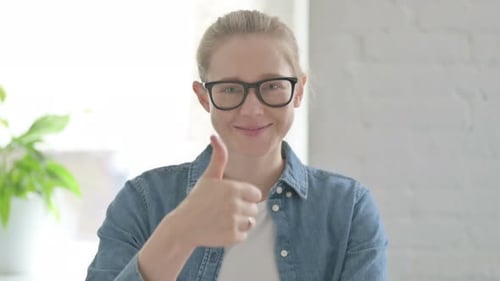 Woman Gives Thumbs Up of Approval Indoors