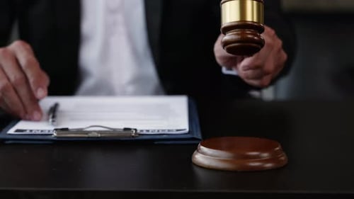 Footage of close of hands of lawyer and client.