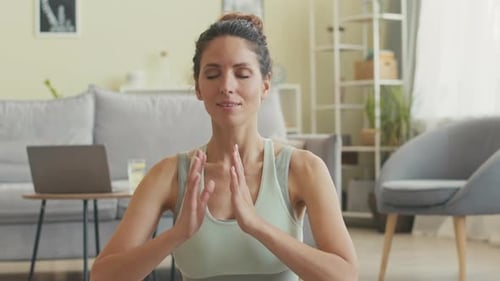 Woman Practicing Yoga Meditation at Home