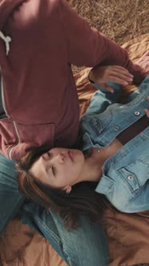 Woman Lying on Man's Lap Outdoors in Field