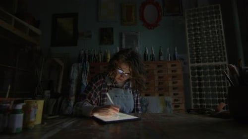 Graphic Designer Using Tablet Computer At Night