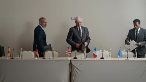 International Delegates Seated at Conference Table for Meeting