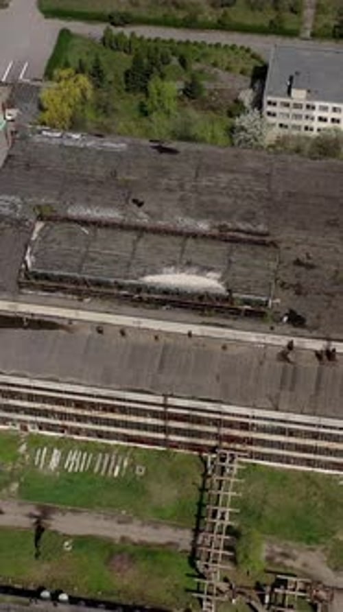 Big abandoned territory of an old factory. Ruined buildings of old industrial plant. Aerial view