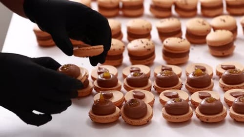 Assembling Chocolate Macarons Dessert in the Workplace
