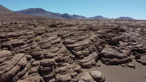 Flyover smooth eroded rock landscape of Valle de las Rocas, Bolivia