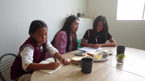 Woman and Children Writing and Cheering Indoors